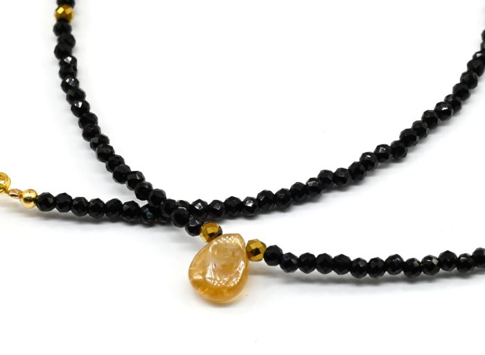 Choker on the neck made of black spinel with a pendant made of amber, honey color, 39cm